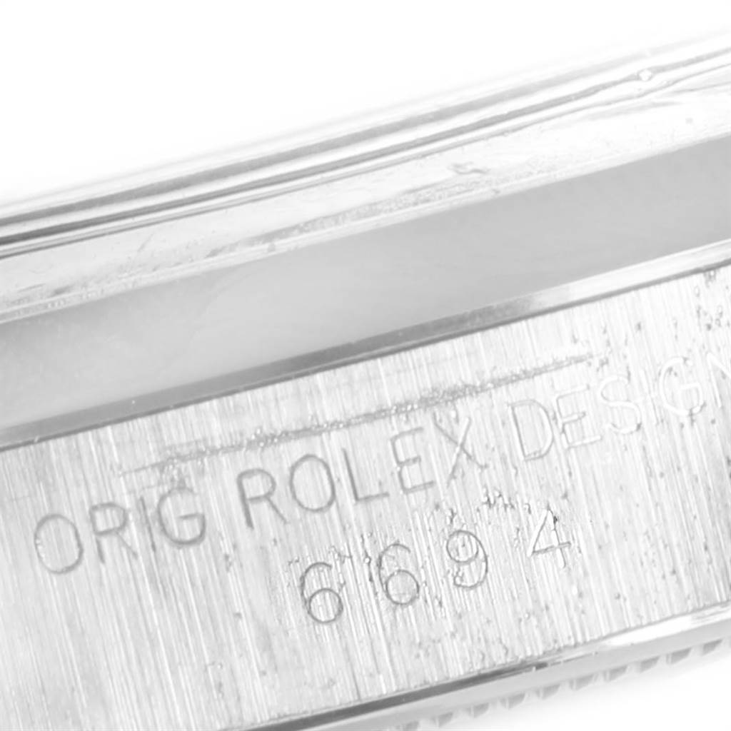 The image shows a close-up view of the side engraving on the case of a Vintage Collection Rolex watch, including "ORIG ROLEX DESIGN" and the model number "6694."
