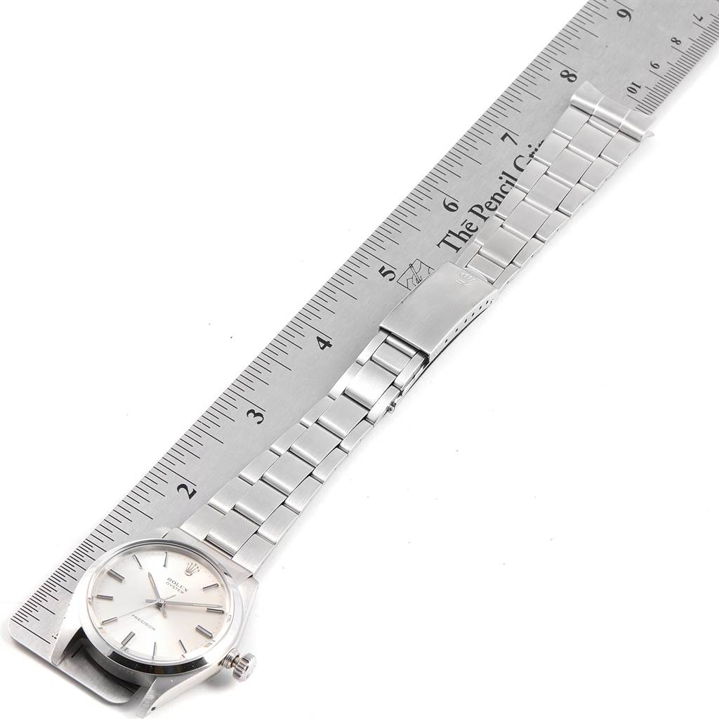 The Rolex Vintage Collection 6694 Men's Stainless Steel Silver Dial 6694 Men's Stainless Steel Silver Dial watch is shown from a top-down angle with the face, bracelet, and clasp displayed alongside a ruler for scale.