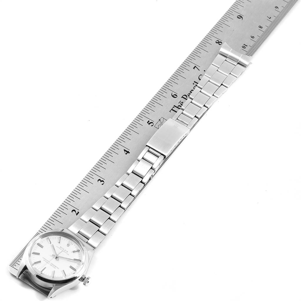 The image shows a Vintage Collection Rolex watch placed next to a ruler, highlighting the watch face and metal bracelet band.