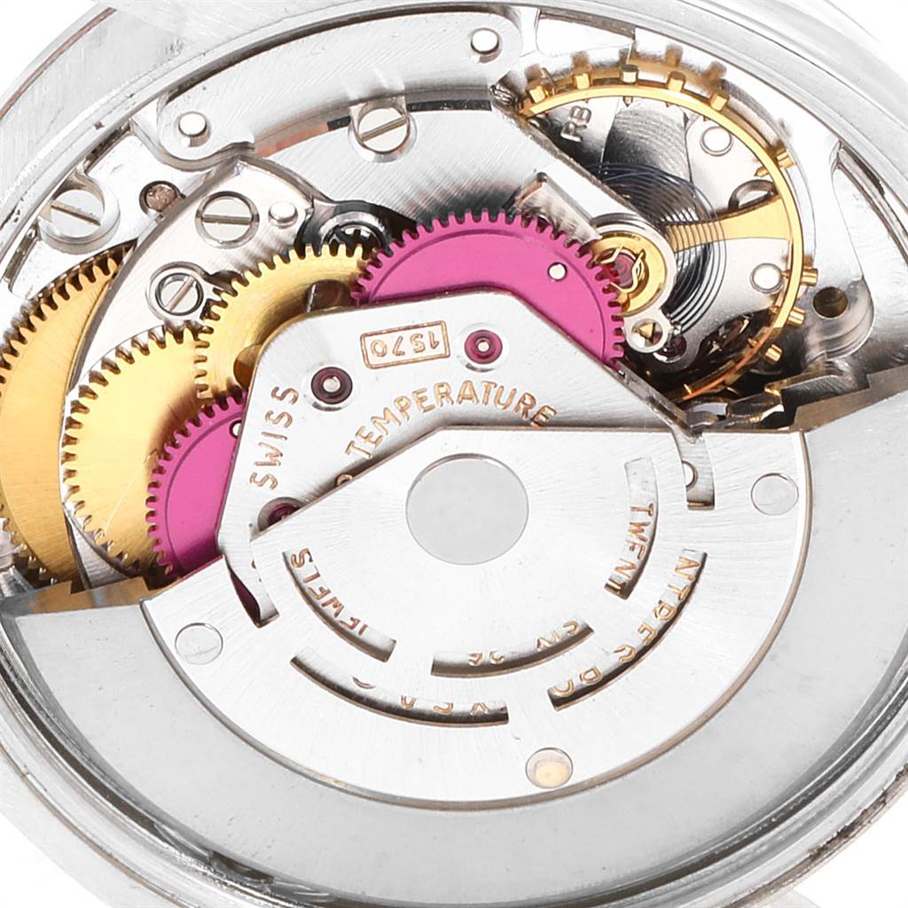 The image shows a close-up view of the internal mechanical components of a Rolex Vintage Collection 1002 Men's Stainless Steel Silver Dial 1002 Men's Stainless Steel Silver Dial watch, focusing on gears and movements.