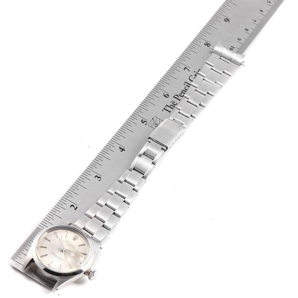 The image shows a top-down view of a Rolex Vintage Collection 1500 Men's Stainless Steel Silver Dial 1500 Men's Stainless Steel Silver Dial model watch, displaying the dial, bracelet, and clasp alongside a ruler.