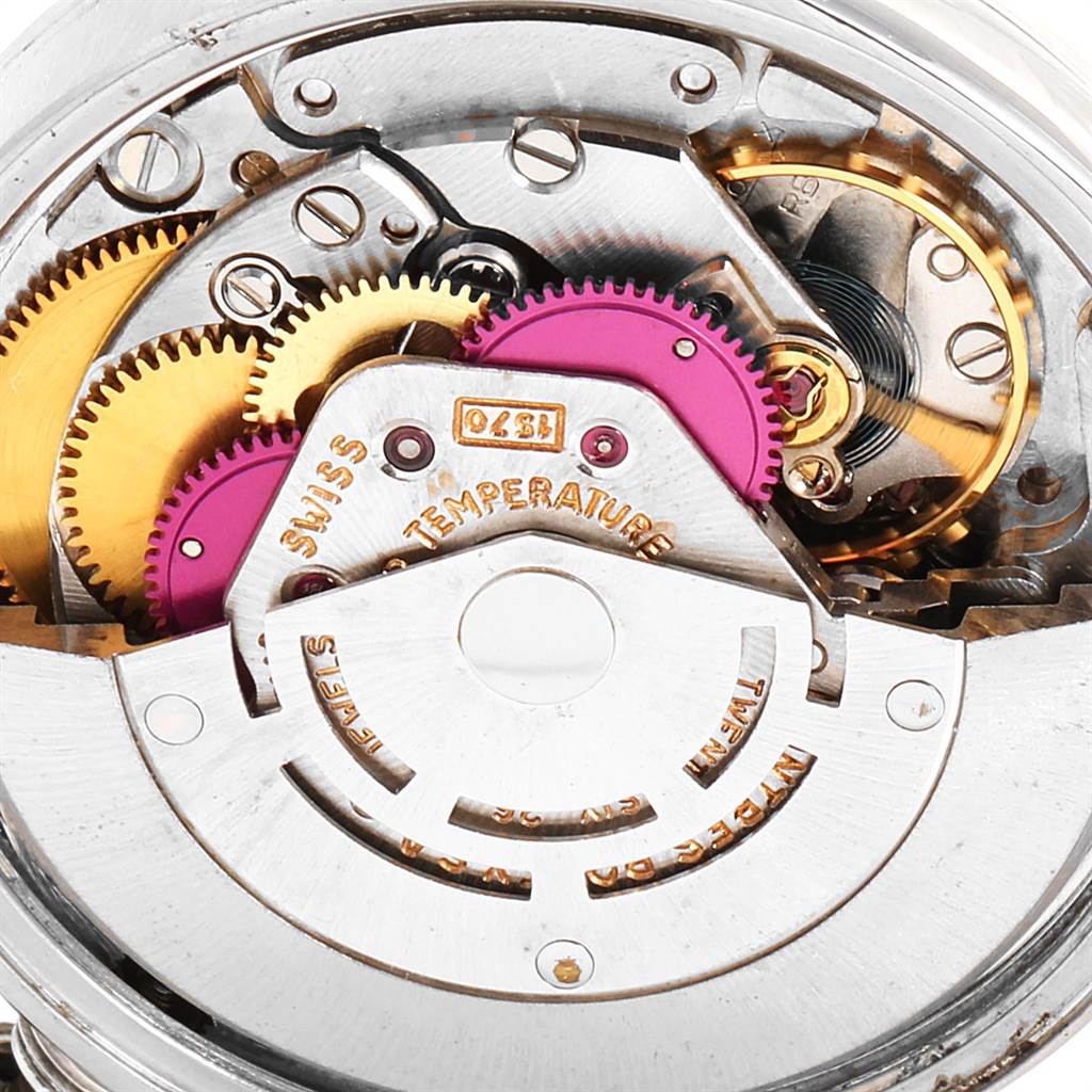This close-up image showcases the intricate gears and mechanisms of a Rolex Vintage Collection 1500 Men's Stainless Steel Silver Dial 1500 Men's Stainless Steel Silver Dial watch's movement.