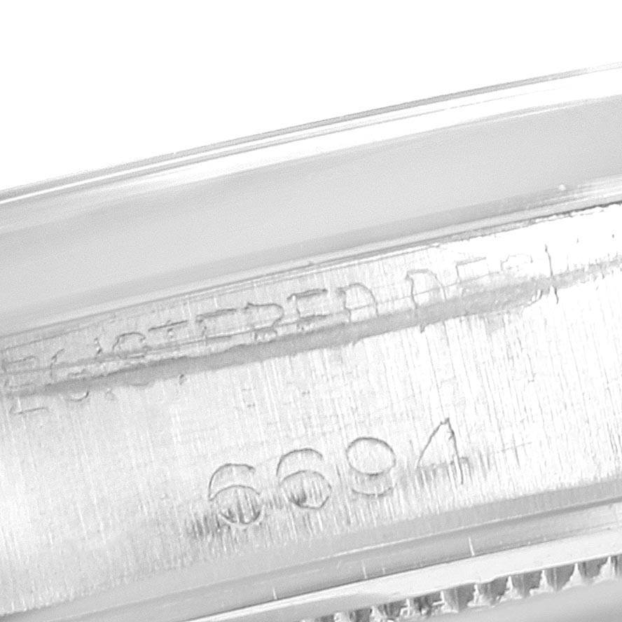 The image shows a close-up of the case, including model number engravings, of a Rolex Vintage Collection 6694 Men's Stainless Steel Silver Dial 6694 Men's Stainless Steel Silver Dial watch.