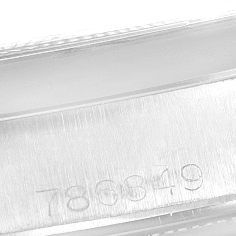 This close-up image shows the serial number engraved on the side of the Rolex Vintage Collection 6694 Men's Stainless Steel Silver Dial 6694 Men's Stainless Steel Silver Dial watch case.