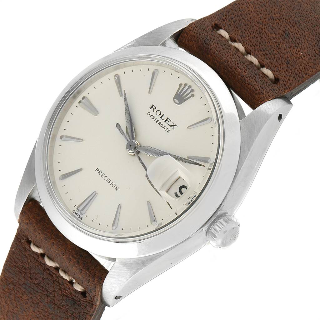 This is a close-up angled view of a Rolex Vintage Collection 6694 Men's Stainless Steel Silver Dial 6694 Men's Stainless Steel Silver Dial watch, showing the dial, crown, case, and a portion of the leather strap.