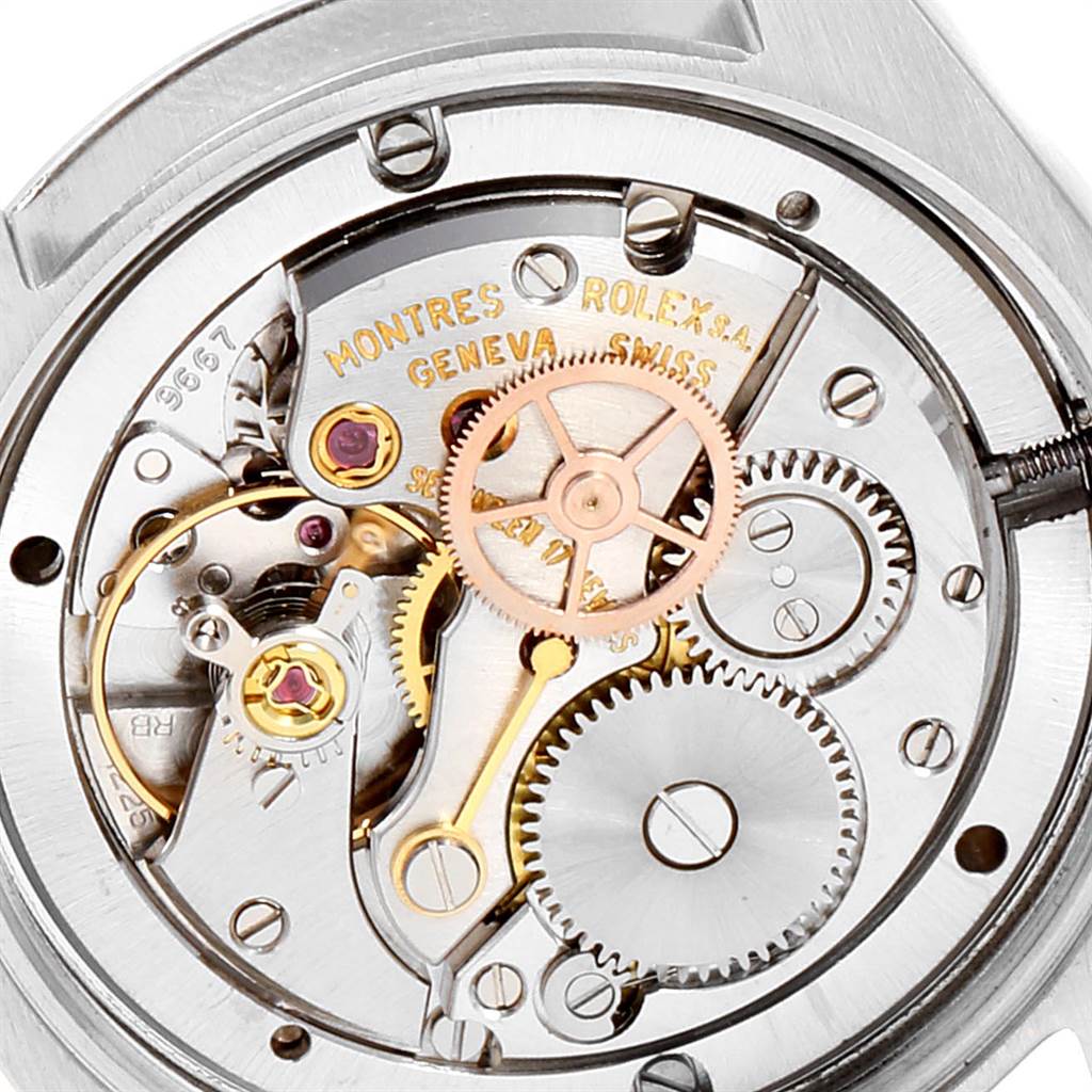 This image shows the open back view of a Vintage Collection Rolex watch, showcasing its internal mechanical movement.