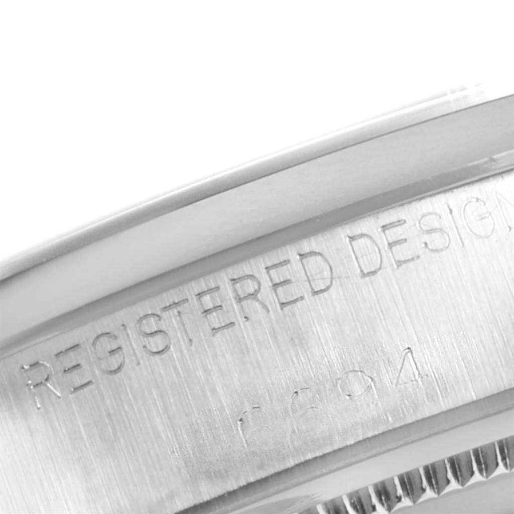 This close-up image shows the engraved edge of the Rolex Vintage Collection 6694 Men's Stainless Steel Silver Dial 6694 Men's Stainless Steel Silver Dial watch case.