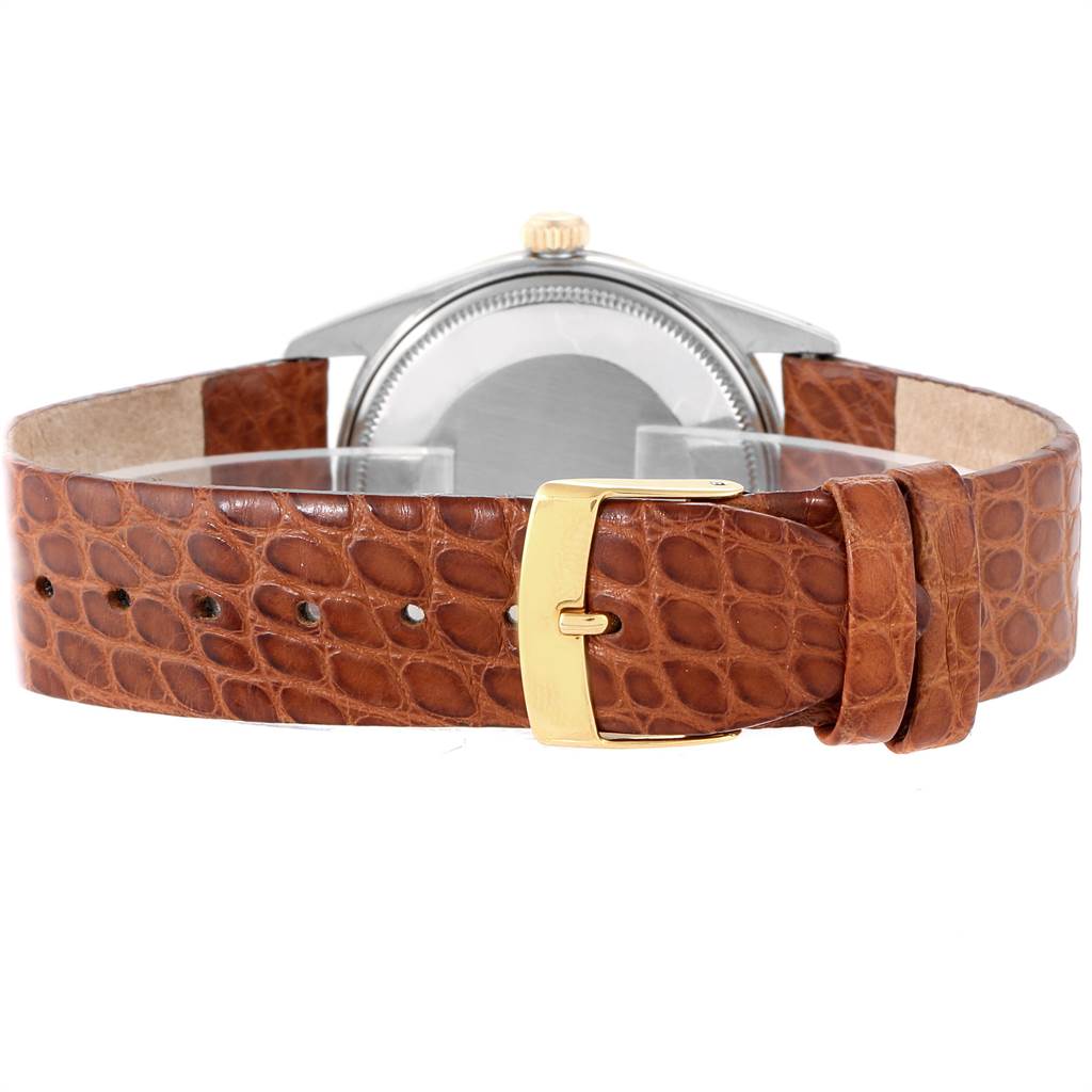 The image shows the back view of a Vintage Collection Rolex watch, focusing on its brown leather strap with a gold buckle.