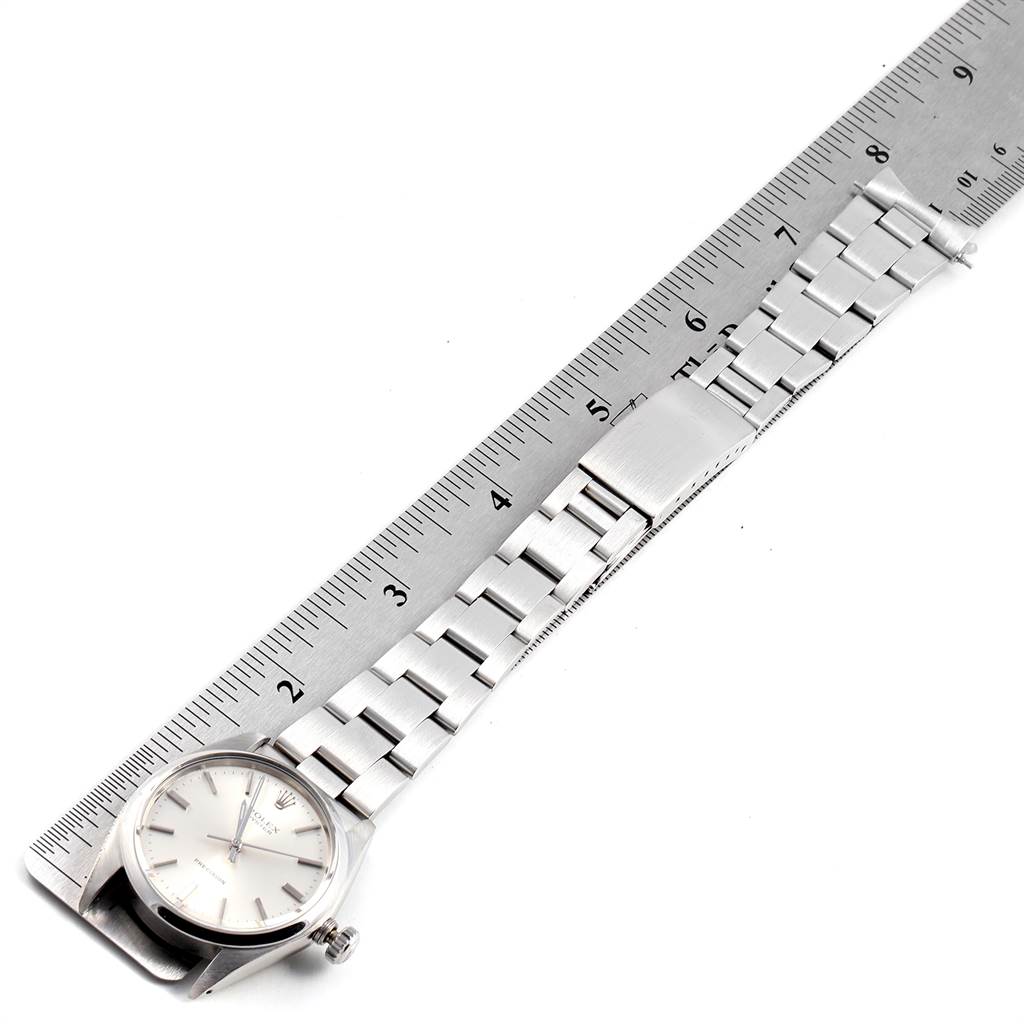 The image shows a top view of the Rolex Vintage Collection 6426 Men's Stainless Steel Silver Dial 6426 Men's Stainless Steel Silver Dial watch, displaying the watch face, bracelet, and a measuring ruler.