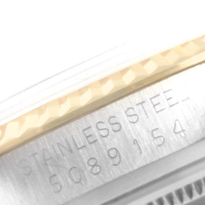 This close-up image of a Rolex Vintage Collection 1601 Men
s Steel and Gold (two tone) Champagne Dial 1601 Men
s Steel and Gold (two tone) Champagne Dial watch shows part of the case with "STAINLESS STEEL" and the serial number.