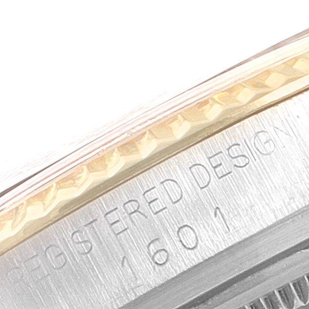 This close-up image shows the side case and part of the bezel of the Rolex Vintage Collection 1601 Men
s Steel and Gold (two tone) Champagne Dial 1601 Men
s Steel and Gold (two tone) Champagne Dial model, highlighting the engraved text.