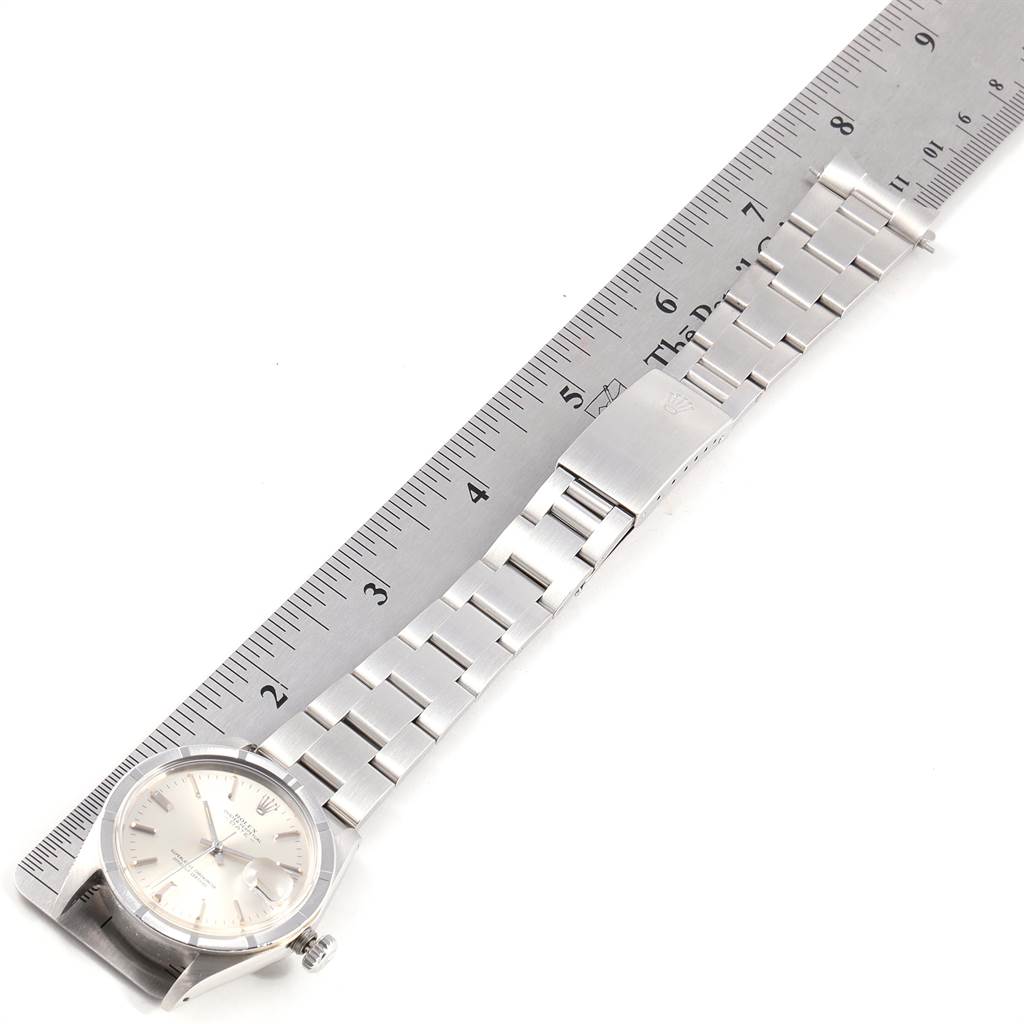 The image shows a top view of a Vintage Collection Rolex watch, including the face, bezel, bracelet, and clasp next to a ruler.