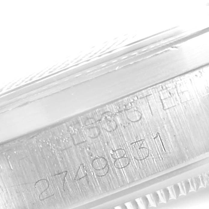 The image shows a close-up side view of a Vintage Collection Rolex watch, focusing on the edge of the case and engravings.