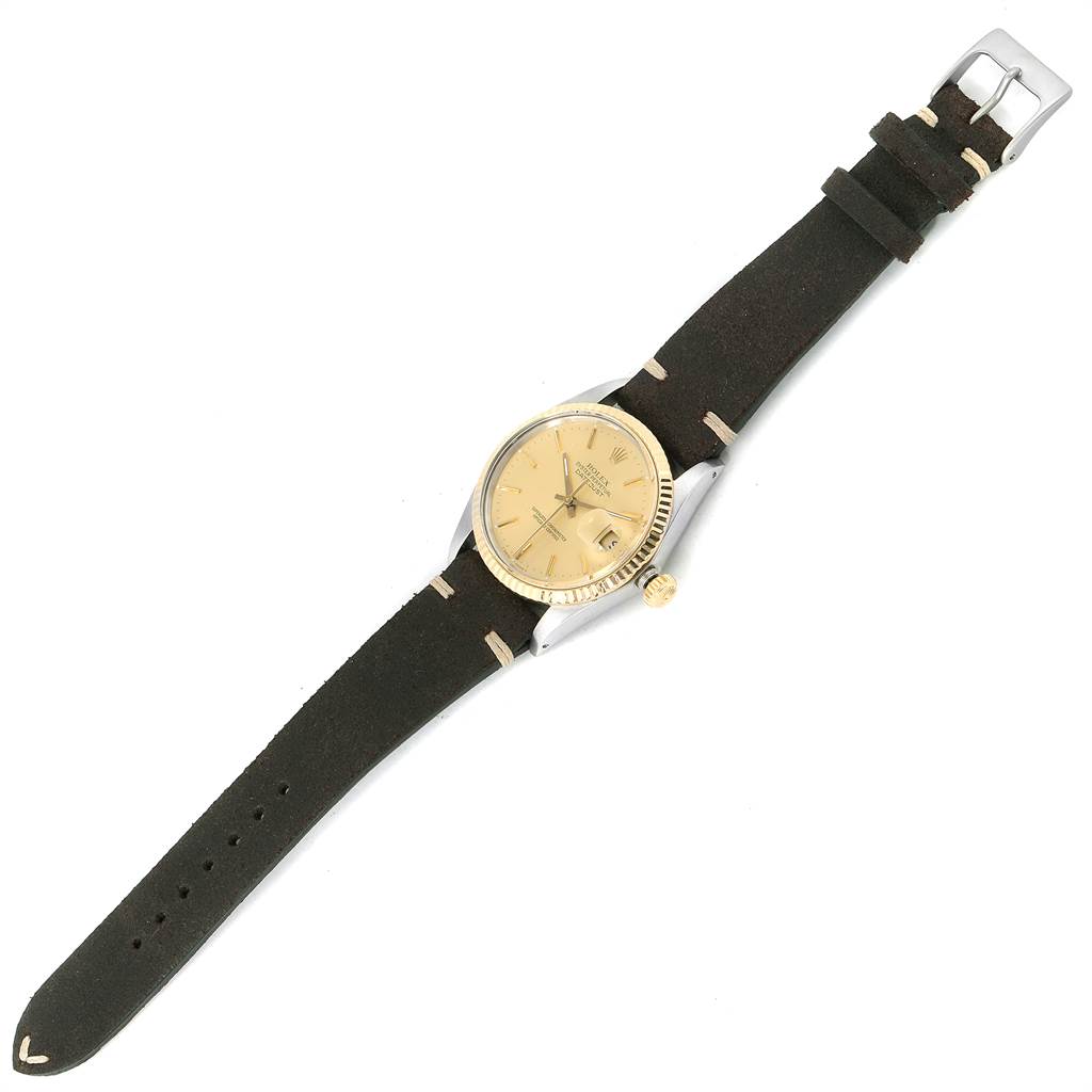 The image shows a Rolex Vintage Collection 16013 Men's Stainless Steel Champagne Dial 16013 Men's Stainless Steel Champagne Dial model watch from a top-down angle, featuring the dial, bezel, crown, and leather strap.