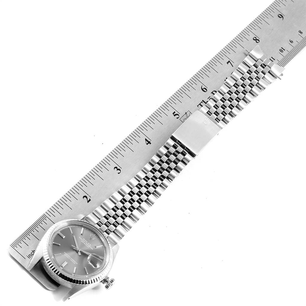 The Vintage Collection Rolex watch is shown from the top, displaying the face, band, and clasp alongside a measuring ruler.