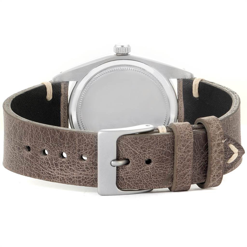 The image shows a rear view of the Rolex Vintage Collection 6694 Men's Stainless Steel Silver Dial 6694 Men's Stainless Steel Silver Dial watch, highlighting the case back and leather strap with buckle.