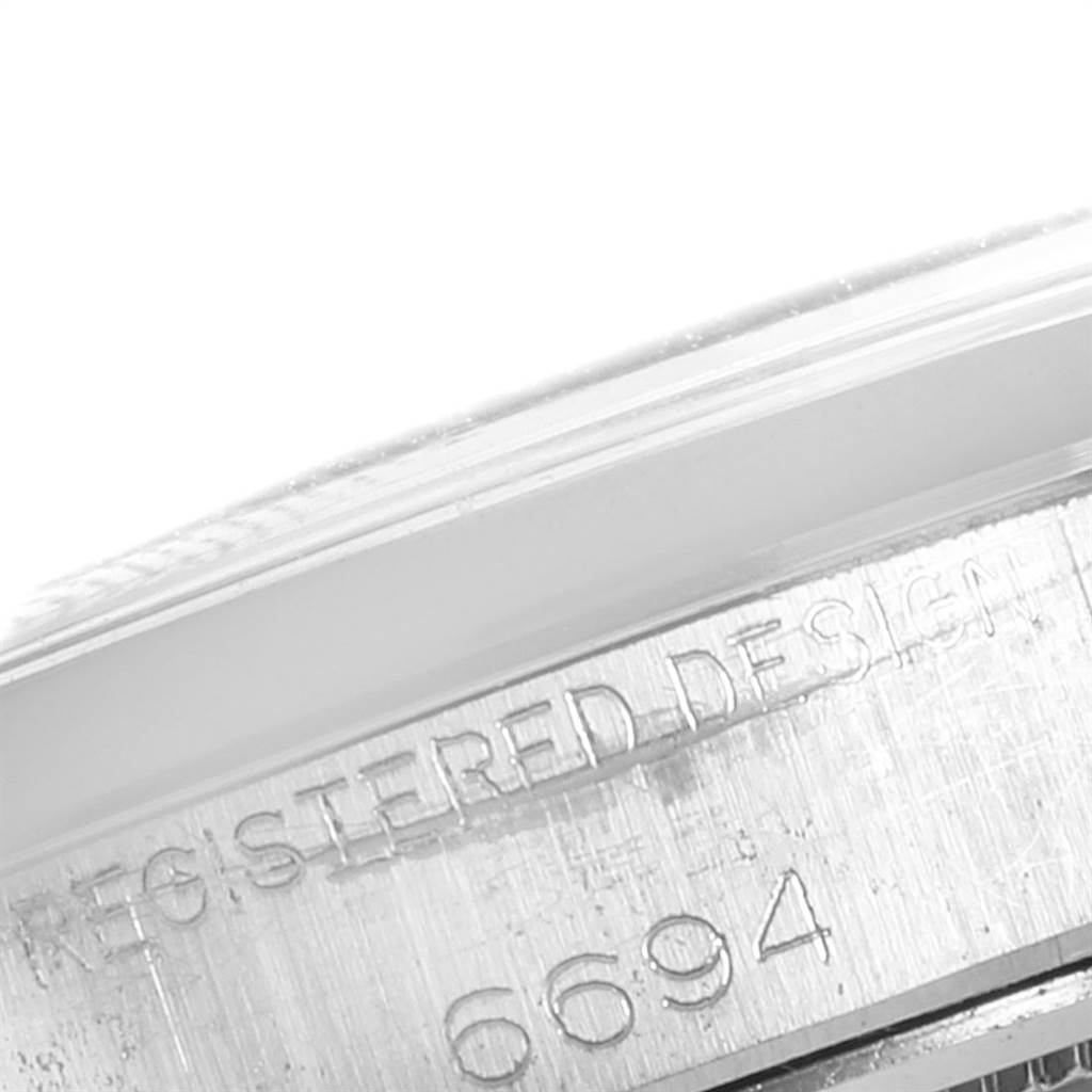 This close-up image shows the side case of a Rolex Vintage Collection 6694 Men's Stainless Steel Silver Dial 6694 Men's Stainless Steel Silver Dial model with the engraved design and model number 6694.