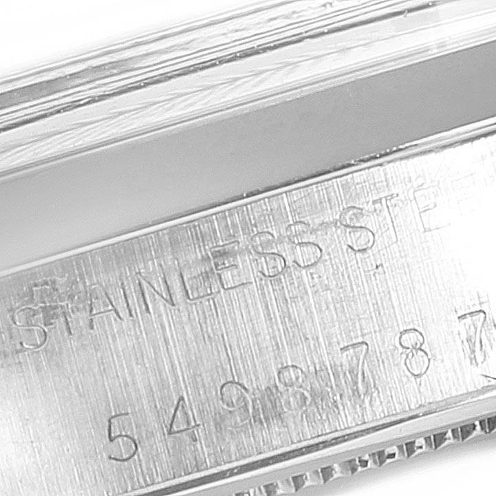 This image shows a close-up angle of the side of a Vintage Collection Rolex watch, displaying its stainless steel engraving and serial number.