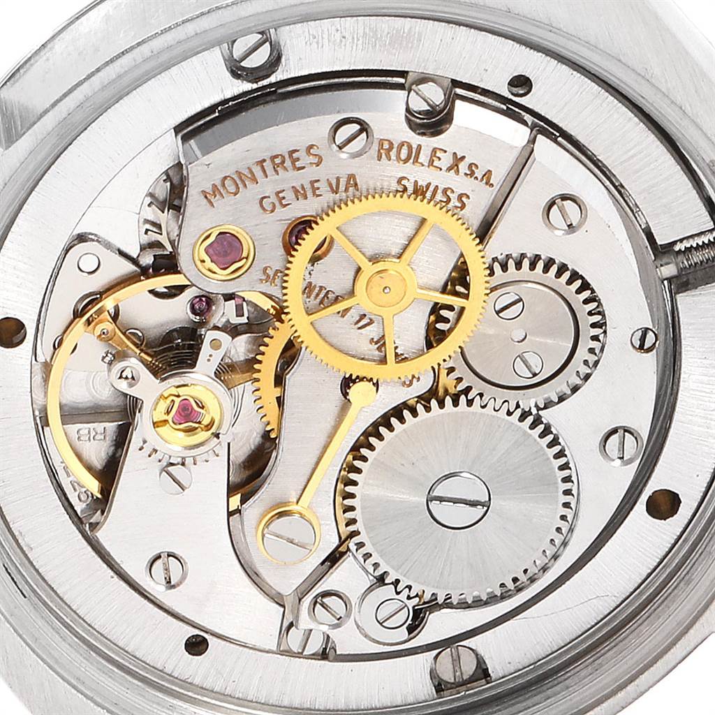 The image shows the intricate inner mechanism of a Rolex Vintage Collection 6694 Men's Stainless Steel Champagne Dial 6694 Men's Stainless Steel Champagne Dial model, highlighting its gears and movement components.