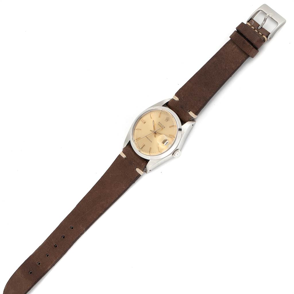 The image shows a Rolex Vintage Collection 6694 Men's Stainless Steel Champagne Dial 6694 Men's Stainless Steel Champagne Dial model watch, featuring a beige dial, brown leather strap, and silver case, captured from a top-down angle.