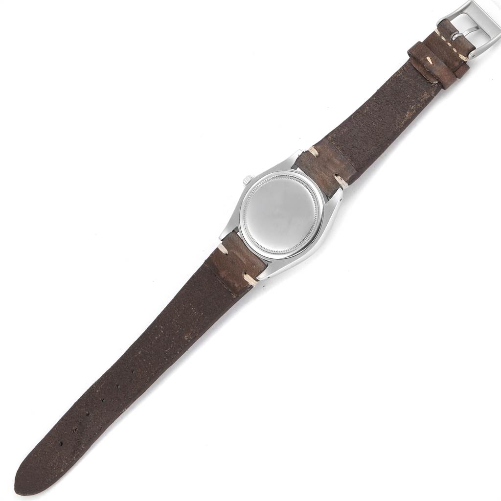 This image shows the backside of a Vintage Collection Rolex watch with a brown leather strap.