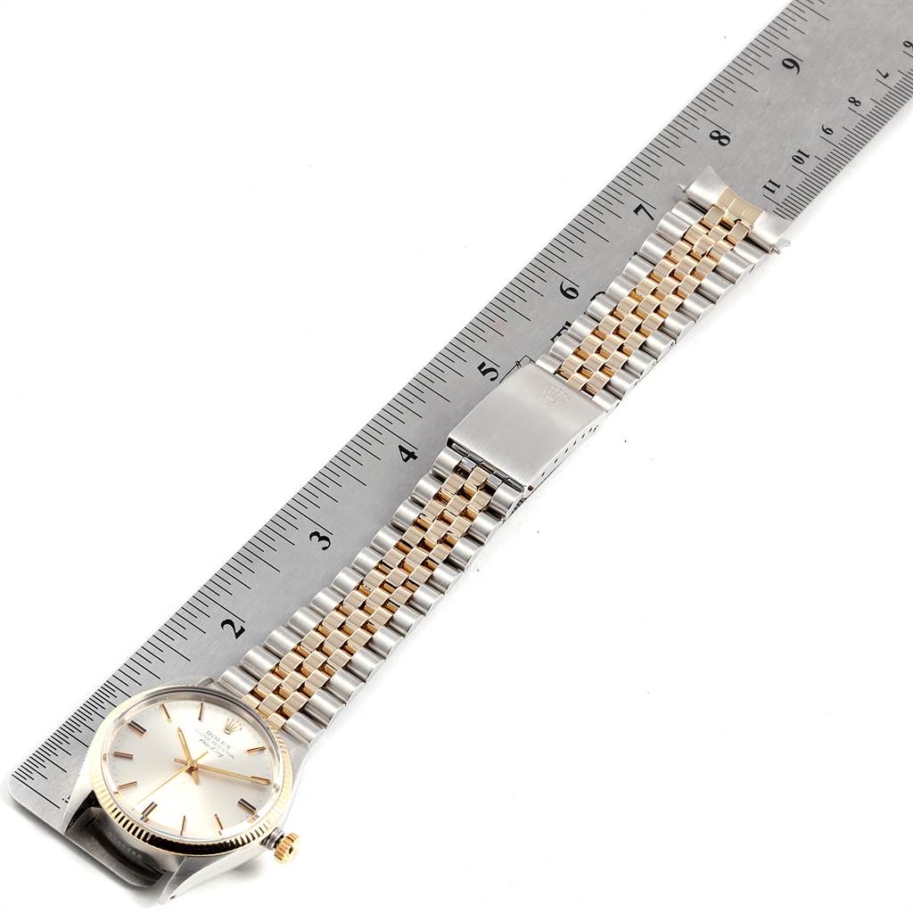 The Vintage Collection Rolex watch is shown from a top-down angle with the face and band alongside a ruler for scale.