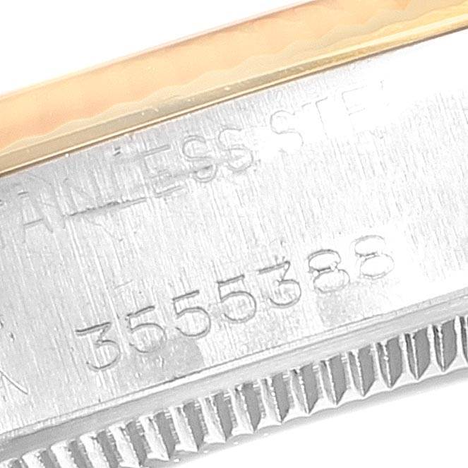 This close-up image shows the serial number and "STAINLESS STEEL" engraving on the Rolex Vintage Collection 5501 Men's Steel and Gold (two tone) Silver Dial 5501 Men's Steel and Gold (two tone) Silver Dial watch case.