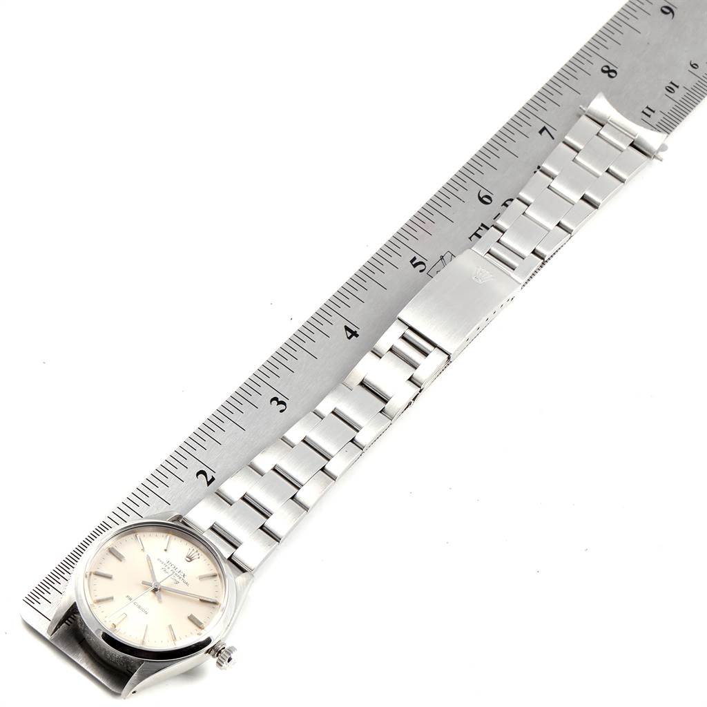 The image shows a Rolex Vintage Collection 5500 Men's Stainless Steel Silver Dial 5500 Men's Stainless Steel Silver Dial watch at a top-down angle, displaying its dial, bracelet, and clasp next to a ruler.