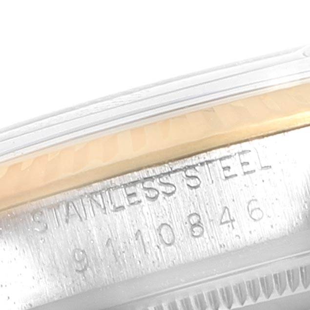 This close-up image of the Vintage Collection Rolex watch shows the side of the stainless steel case with engravings.