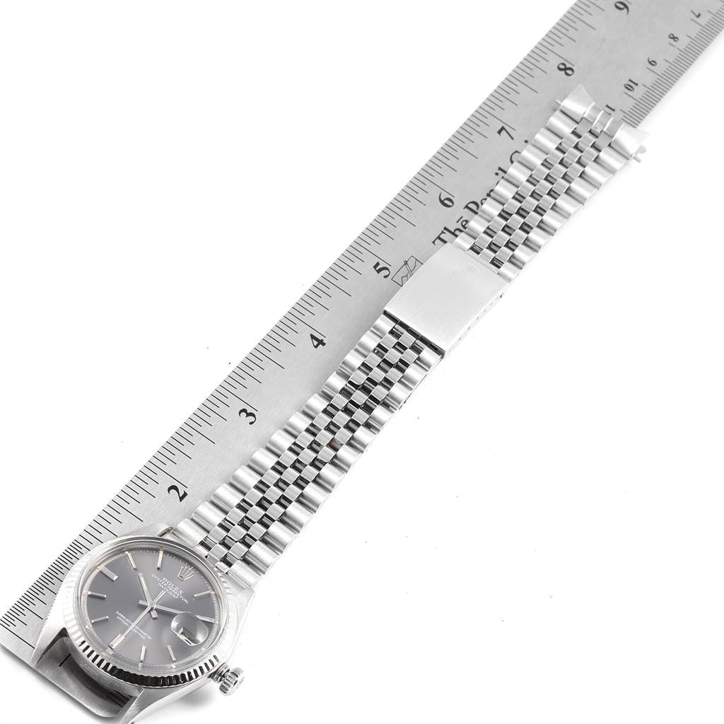 The image shows a Rolex Vintage Collection 1601 Men's Stainless Steel Grey Dial 1601 Men's Stainless Steel Grey Dial watch with its bracelet, measured with a steel ruler.