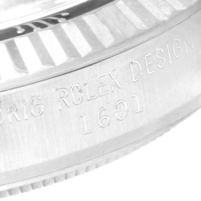 The image shows a close-up of the side case of a Rolex Vintage Collection 1601 Men's Stainless Steel Green Dial 1601 Men's Stainless Steel Green Dial model 1601, featuring engraved markings.
