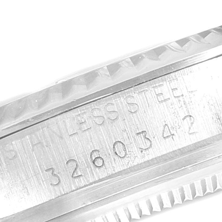Close-up of the serial number and stainless steel engraving on the bezel of the Vintage Collection watch by Rolex.