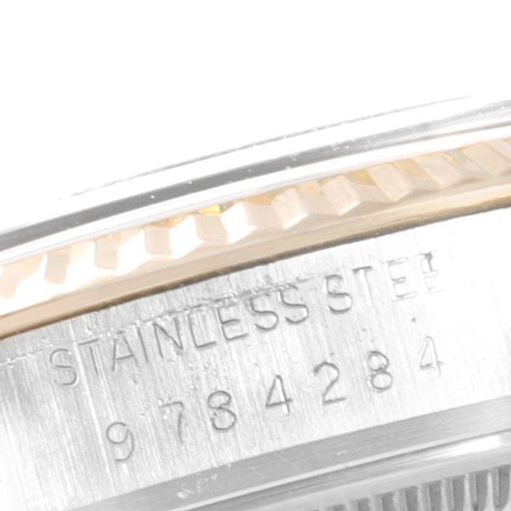 This image shows a close-up of the side of the case and bezel of a Rolex Vintage Collection 16013 Men's Stainless Steel Champagne Dial 16013 Men's Stainless Steel Champagne Dial watch with visible serial and material stamp.