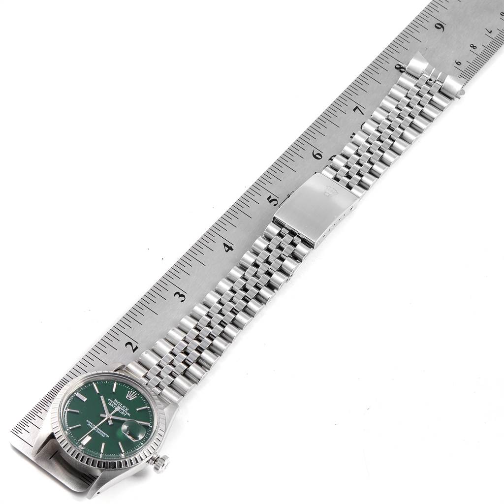 The Rolex Vintage Collection 1603 Men's Stainless Steel Green Dial 1603 Men's Stainless Steel Green Dial watch is shown from a top-down angle, highlighting the green dial, bracelet, and clasp next to a ruler.