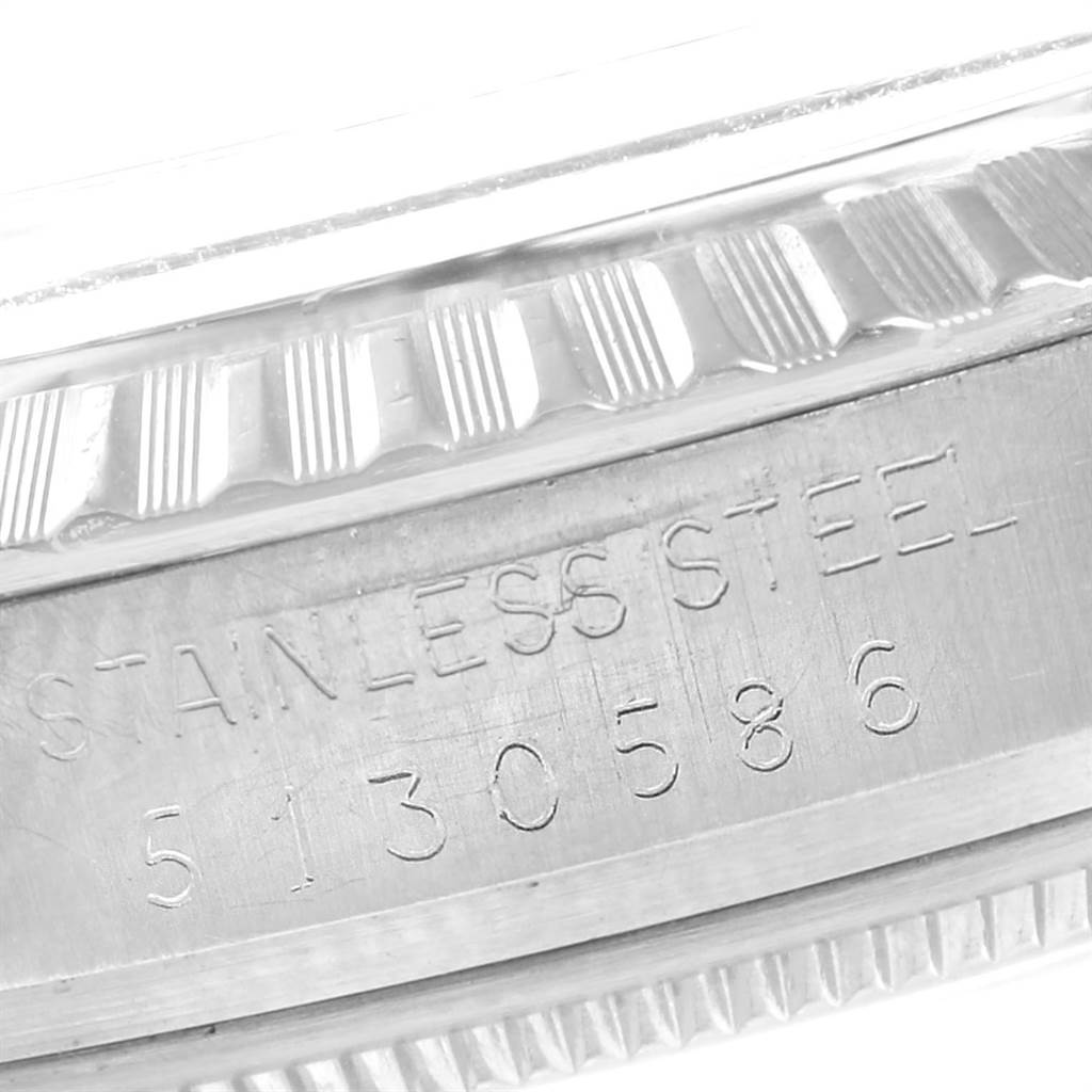 The image shows a close-up of the case side of a Rolex Vintage Collection 1603 Men's Stainless Steel Green Dial 1603 Men's Stainless Steel Green Dial model, highlighting the engraved serial number and "STAINLESS STEEL" text.