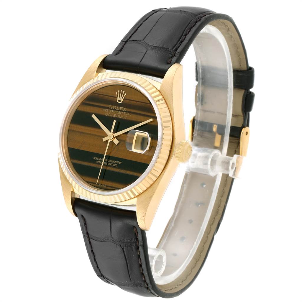 The image shows a side angle of the Rolex Vintage Collection 16018 Men's Yellow Gold Brown Dial 16018 Men's Yellow Gold Brown Dial watch, highlighting its face, bezel, and black leather strap.