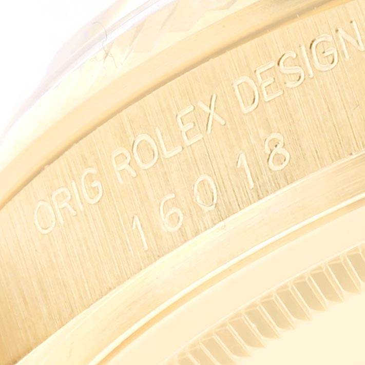 This close-up image shows the engraved case side of the Rolex Vintage Collection 16018 Men's Yellow Gold Brown Dial 16018 Men's Yellow Gold Brown Dial model 16018.