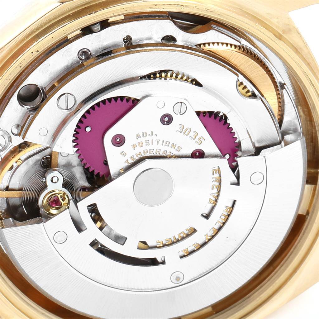 This close-up image shows the intricate inner movement of a Rolex Vintage Collection 16018 Men's Yellow Gold Brown Dial 16018 Men's Yellow Gold Brown Dial watch, including gears and engraving details.