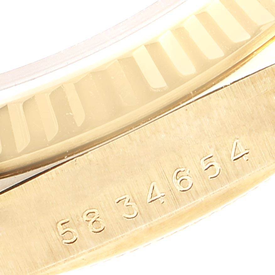 This image shows a close-up of the serial number and a portion of the bezel of a Rolex Vintage Collection 16018 Men's Yellow Gold Brown Dial 16018 Men's Yellow Gold Brown Dial model watch.
