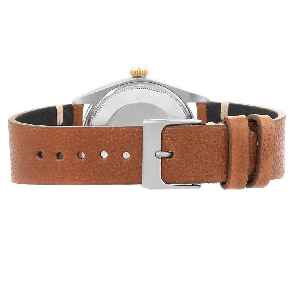 The image shows the back view of the Rolex Vintage Collection 1005 Men
s Steel and Gold (two tone) Silver Dial 1005 Men
s Steel and Gold (two tone) Silver Dial watch, highlighting its leather strap and buckle.