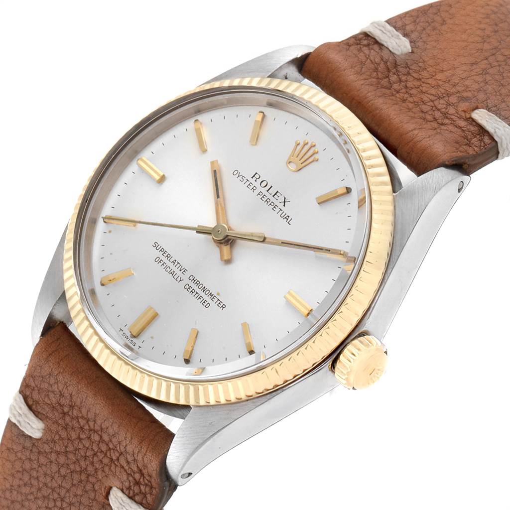 The image displays a Rolex Vintage Collection 1005 Men
s Steel and Gold (two tone) Silver Dial 1005 Men
s Steel and Gold (two tone) Silver Dial watch from an angled top view, highlighting the dial, bezel, crown, and leather strap.