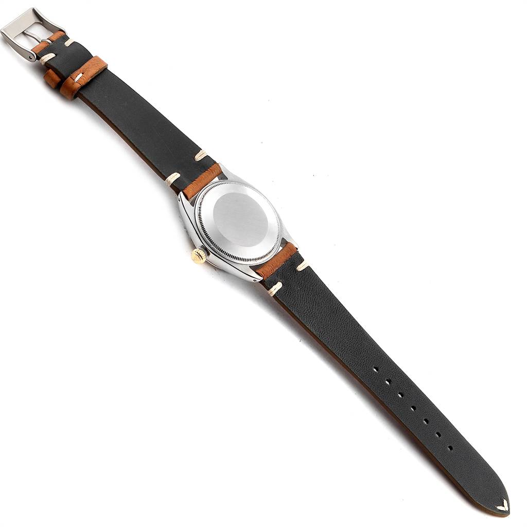 This image shows the back view of the Rolex Vintage Collection 1005 Men
s Steel and Gold (two tone) Silver Dial 1005 Men
s Steel and Gold (two tone) Silver Dial watch, highlighting the case back and leather strap.