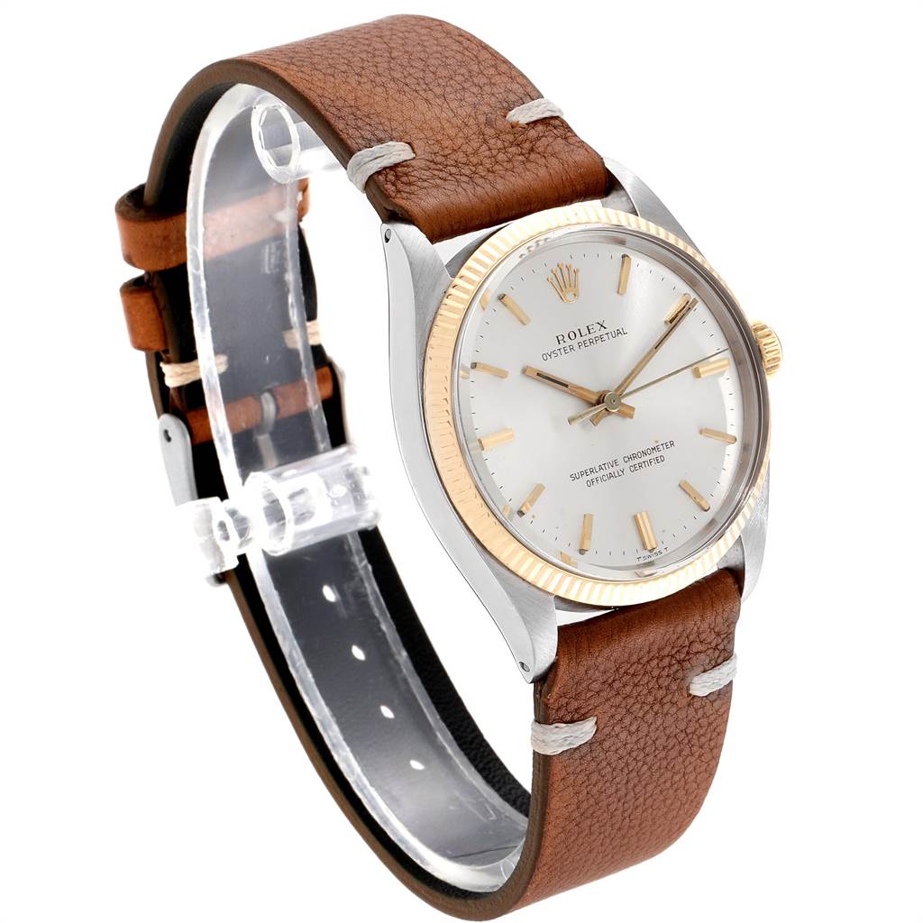 This Rolex Vintage Collection 1005 Men
s Steel and Gold (two tone) Silver Dial 1005 Men
s Steel and Gold (two tone) Silver Dial watch is shown at a 3/4 angle from its right side, displaying its brown leather strap and gold-accented face.