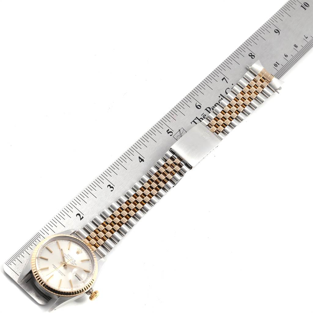 The Rolex Vintage Collection 16013 Men's Stainless Steel Silver Dial 16013 Men's Stainless Steel Silver Dial watch is shown from the top view, displaying its face and metal band next to a ruler for measurement.