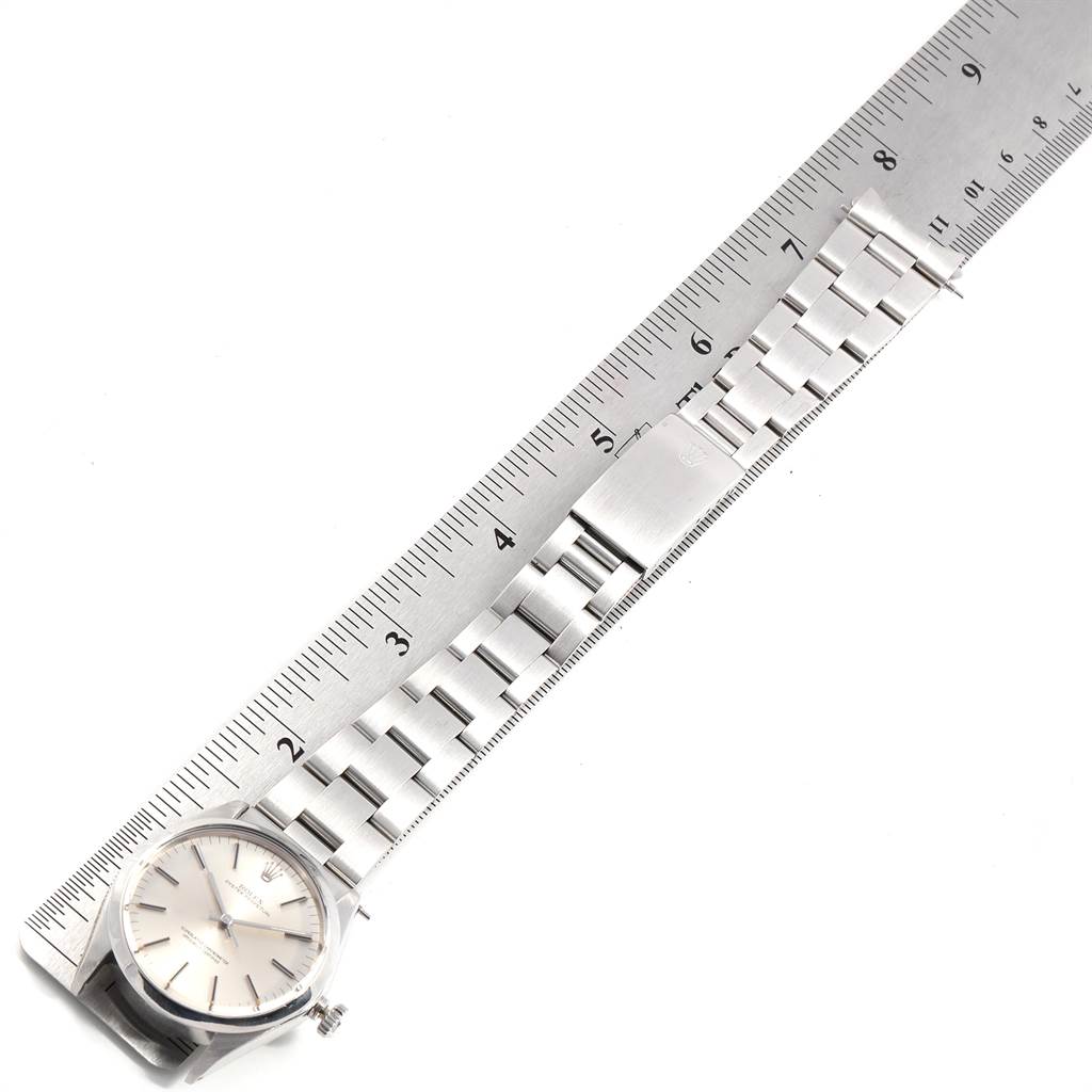 The image shows the Rolex Vintage Collection 1002 Men's Stainless Steel Silver Dial 1002 Men's Stainless Steel Silver Dial watch from a top-down angle, highlighting the face and metal bracelet with a ruler for scale.