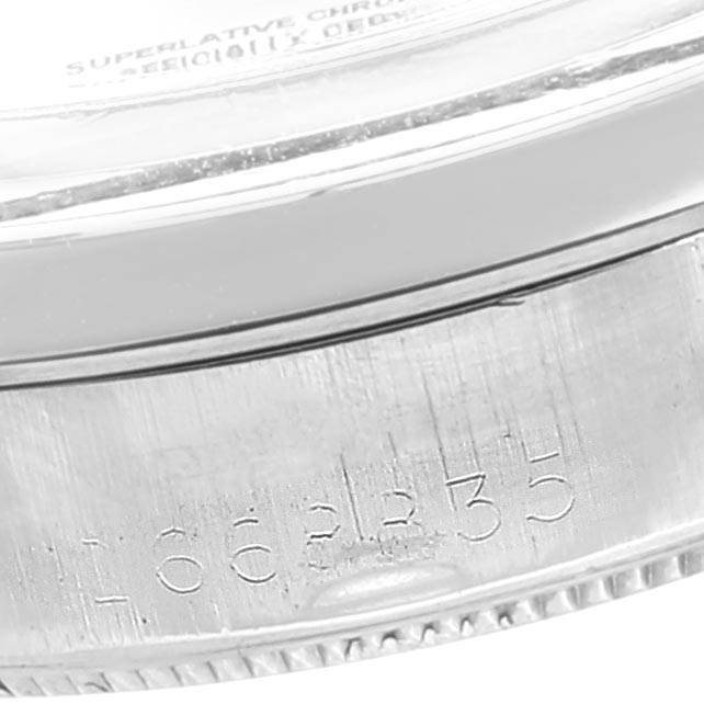 This image shows a close-up of the side of a Rolex Vintage Collection 1002 Men's Stainless Steel Silver Dial 1002 Men's Stainless Steel Silver Dial model watch, focusing on the serial number engraving.