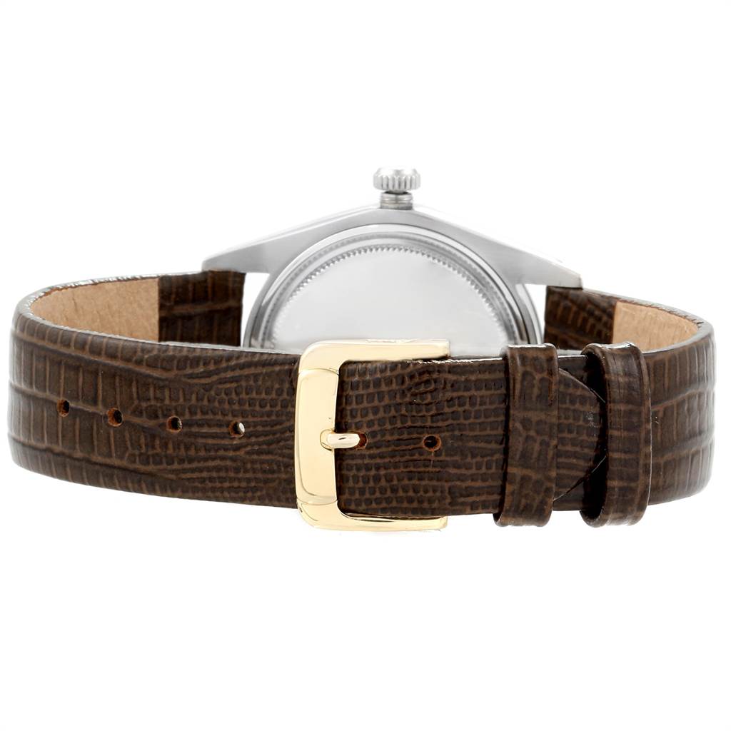 The image shows the back view of the Rolex Vintage Collection 6694 Men's Stainless Steel Silver Dial 6694 Men's Stainless Steel Silver Dial watch, highlighting the case and brown leather strap with a gold buckle.