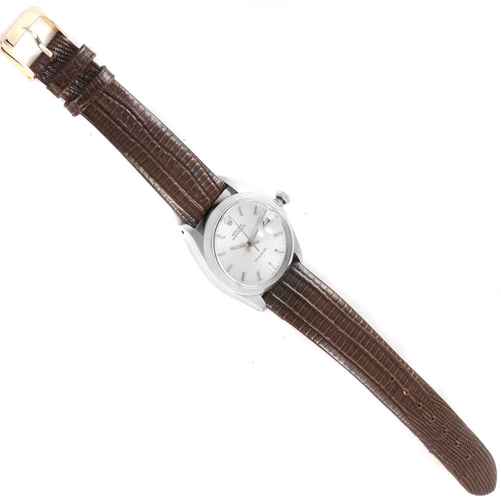 The Rolex Vintage Collection 6694 Men's Stainless Steel Silver Dial 6694 Men's Stainless Steel Silver Dial watch shown is viewed from the top, featuring a silver case and a brown leather strap with a gold buckle.