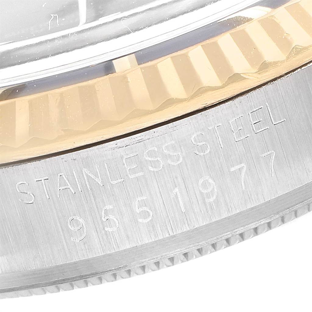 The image shows a close-up of the stainless steel bezel with engraved details on a Vintage Collection model by Rolex.
