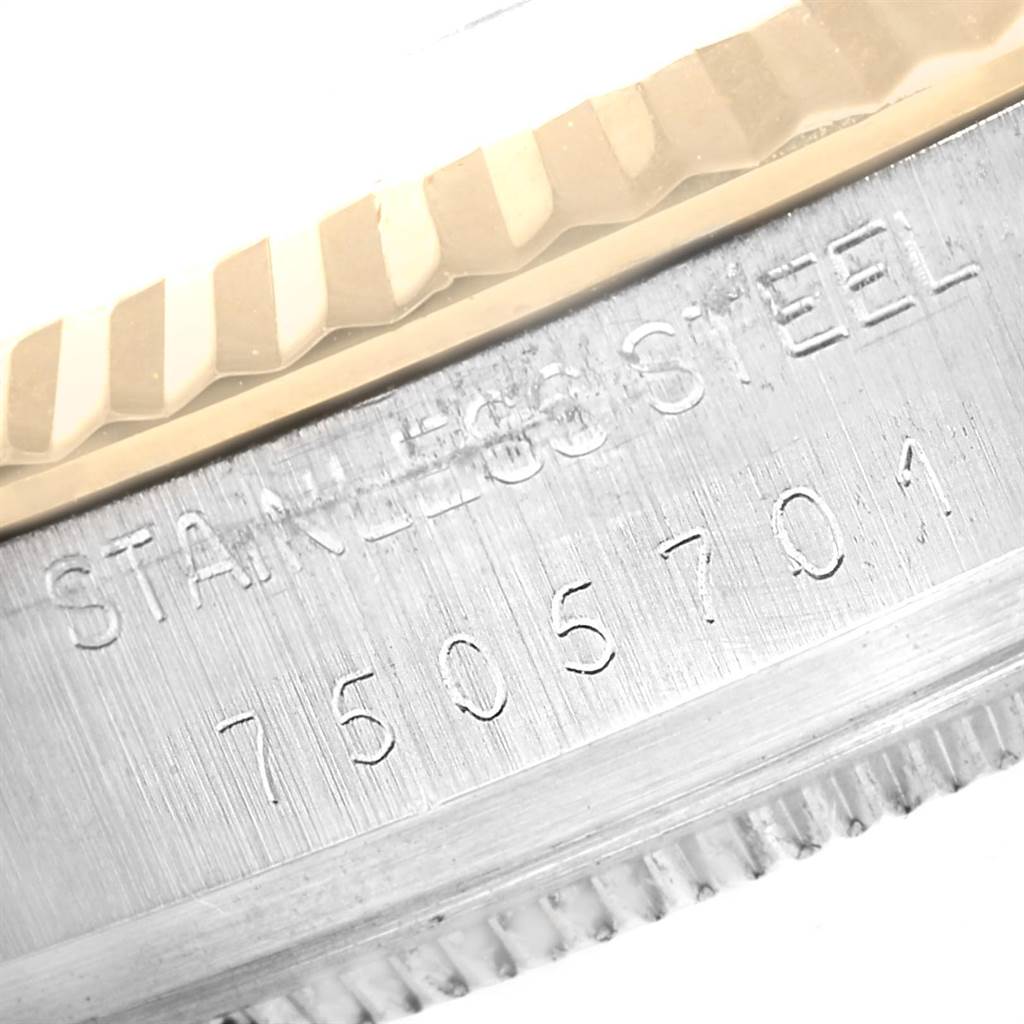 This close-up image of the Vintage Collection Rolex watch shows the serial number and part of the stainless steel case.